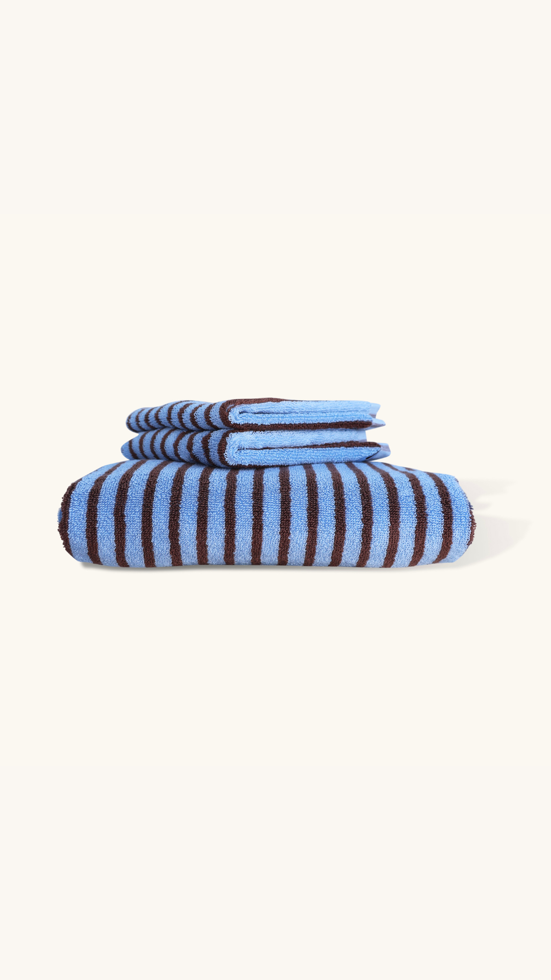 Folded blue and white striped towel on a white background