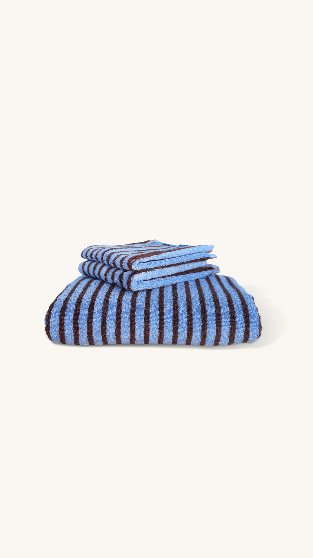 Stack of blue and white striped towels on a white background