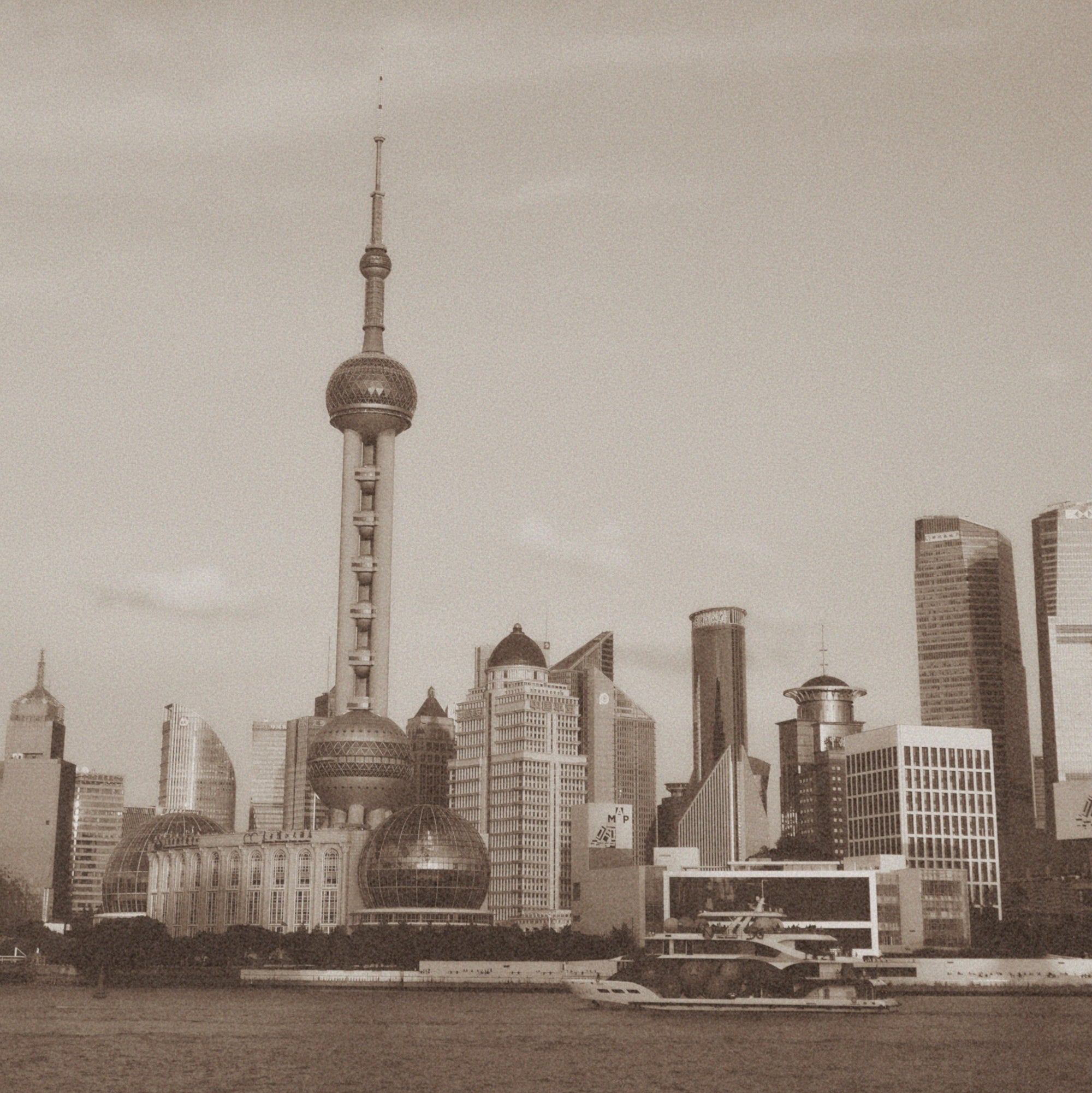 Shanghai skyline with a prominent tower and modern buildings.