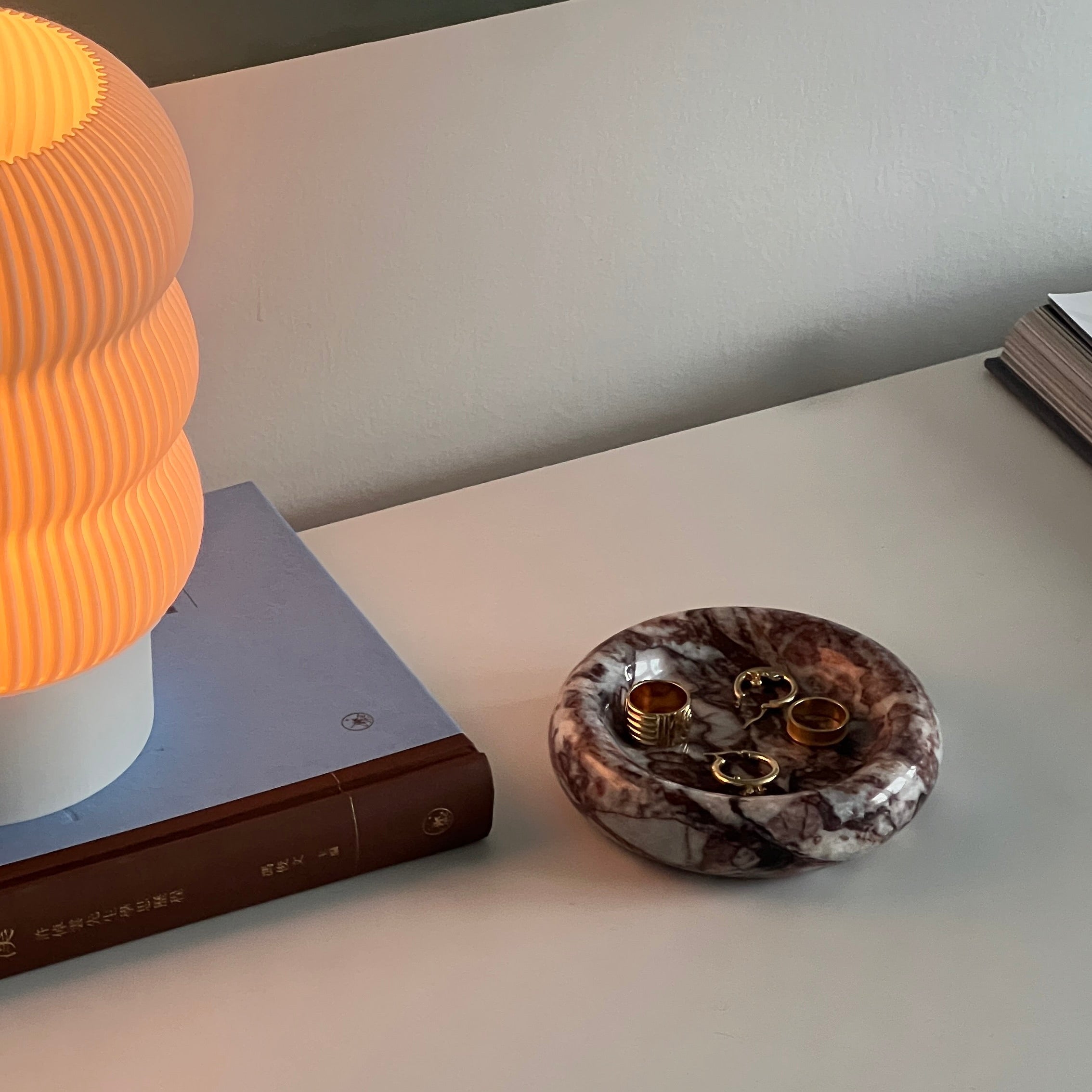 Decorative object on a shelf next to a lamp