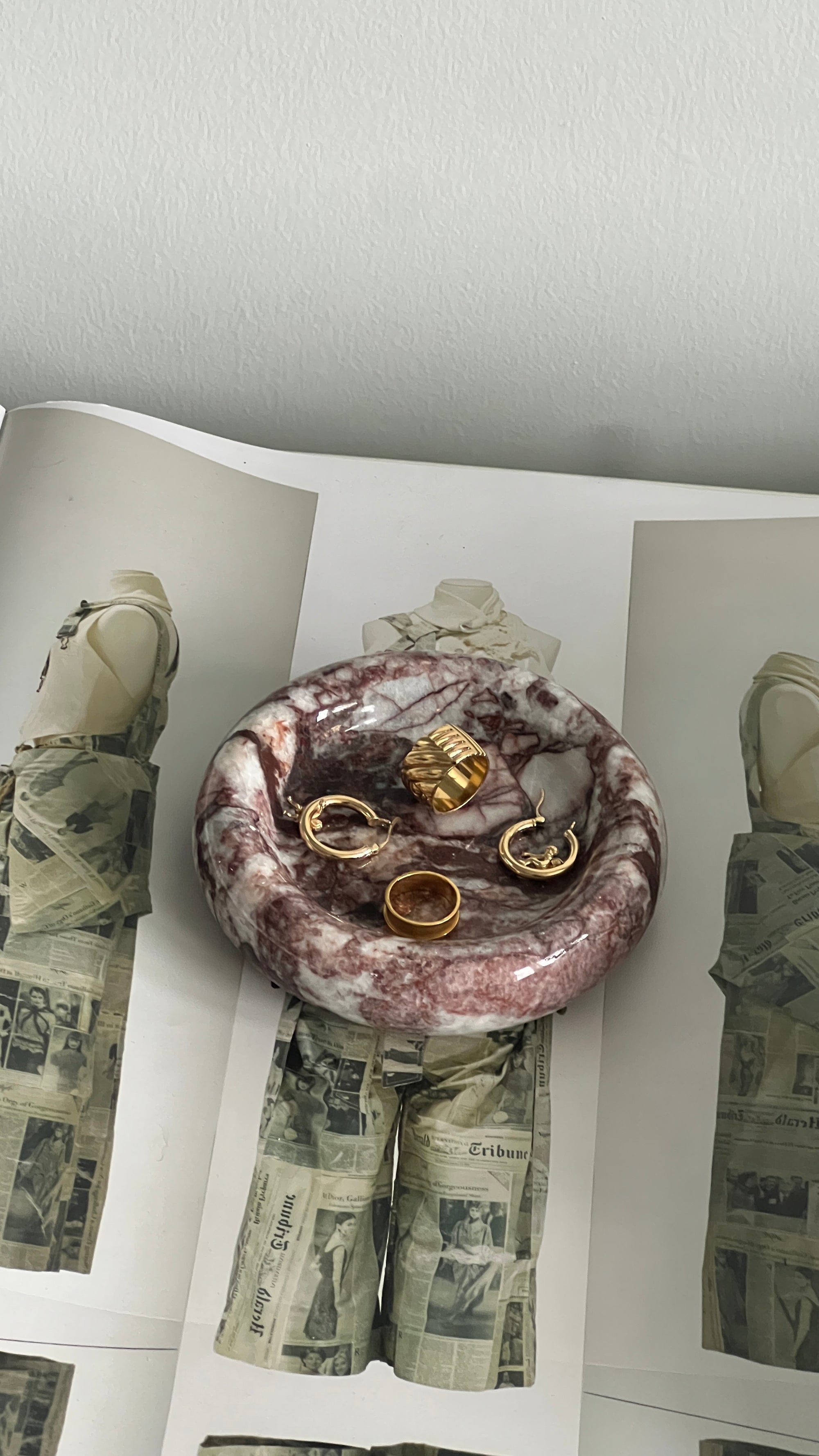 Marble bowl with jewelry on a magazine spread