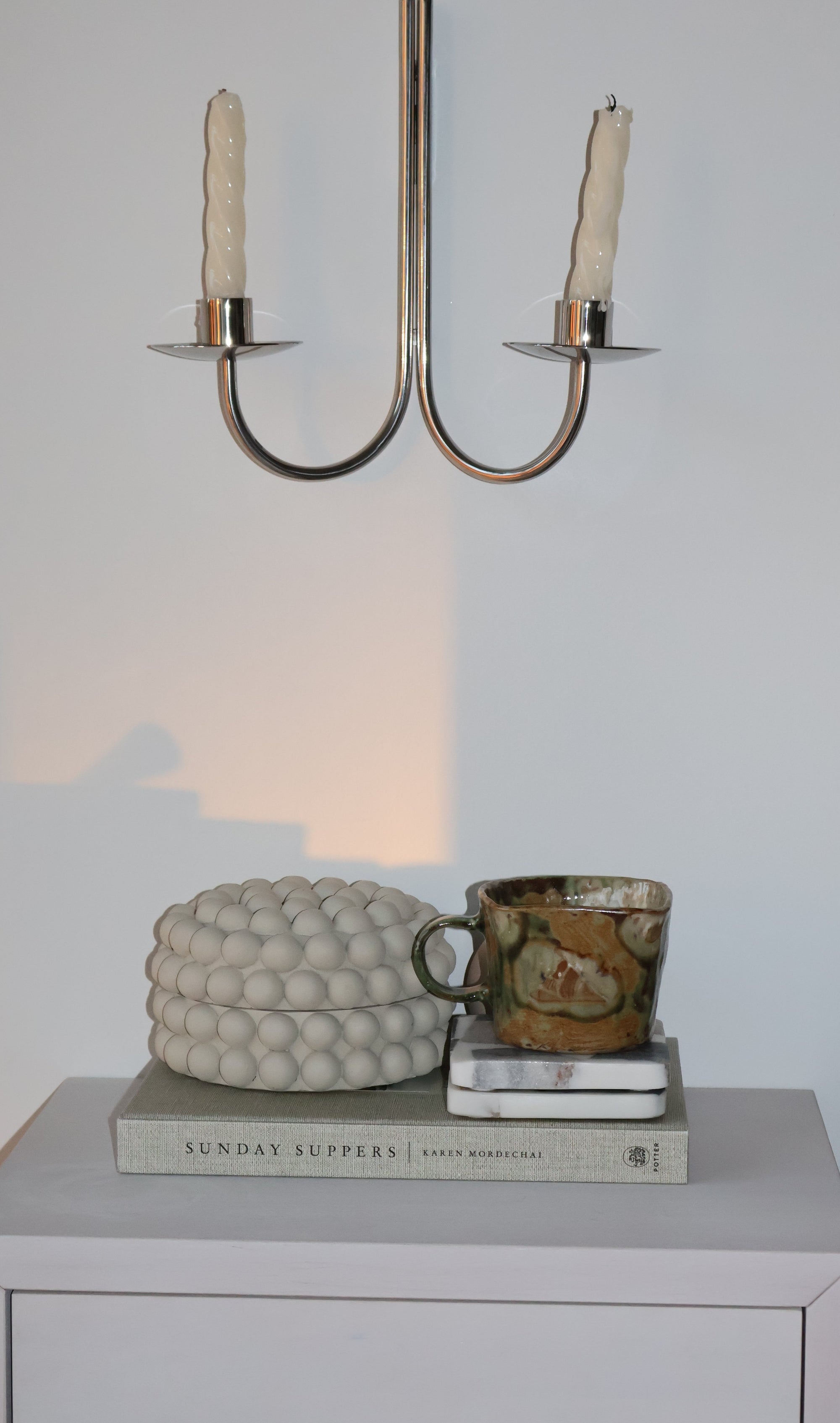 Close-up of a jewelry box with a key and decorative item on a light background