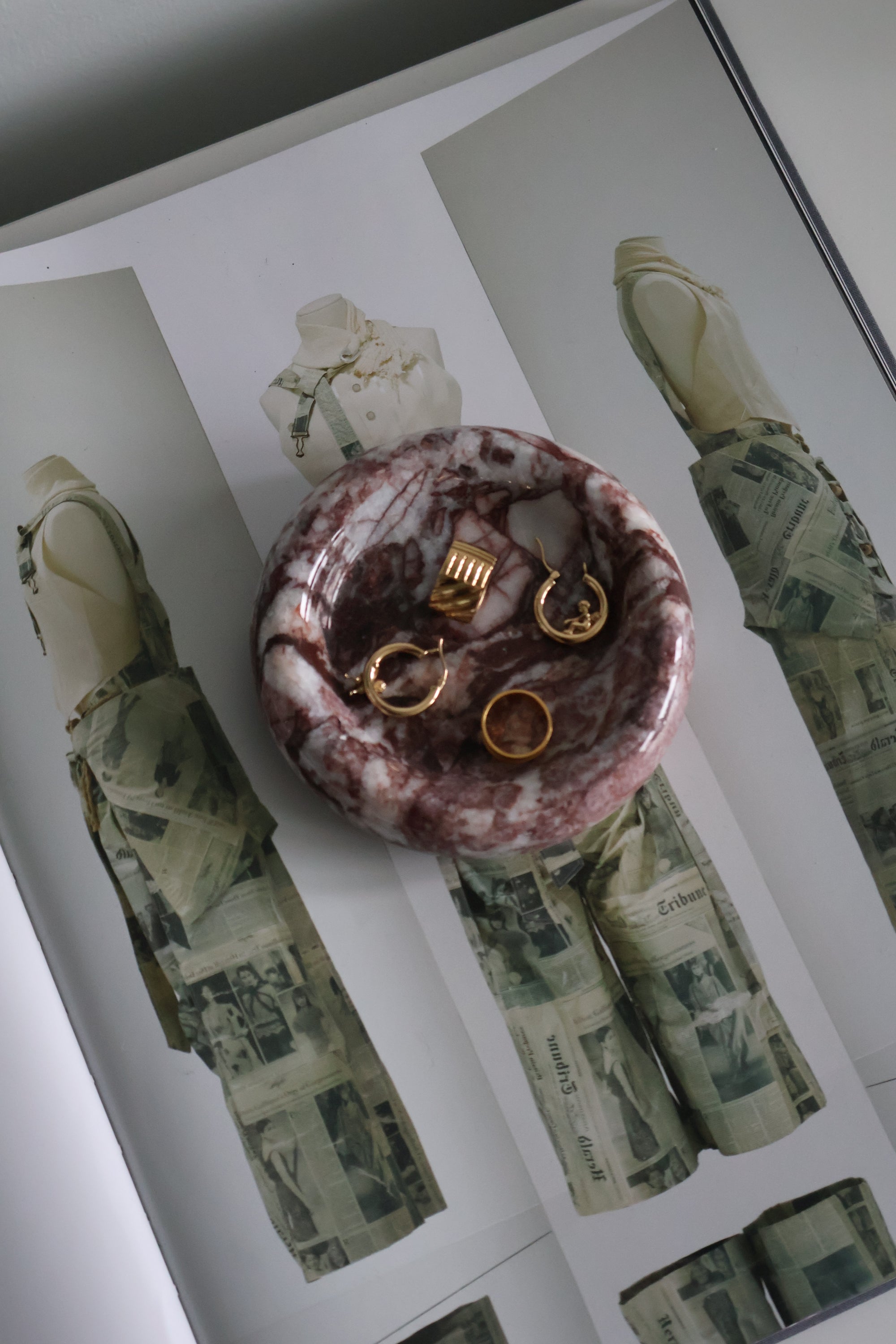 Jewelry set on a decorative stone surface with camouflage-patterned money in the background