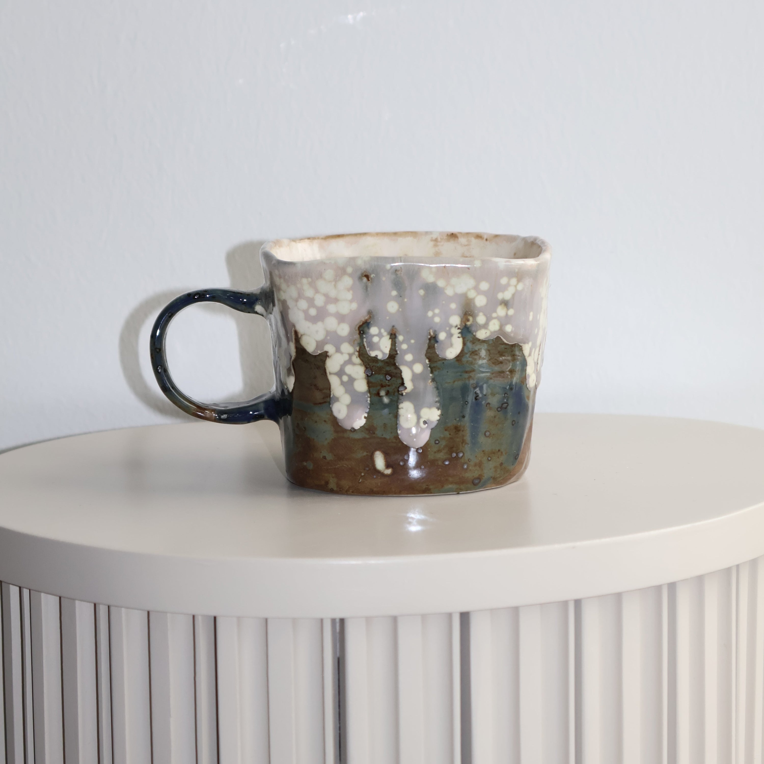 Ceramic cup with textured surface on a white background