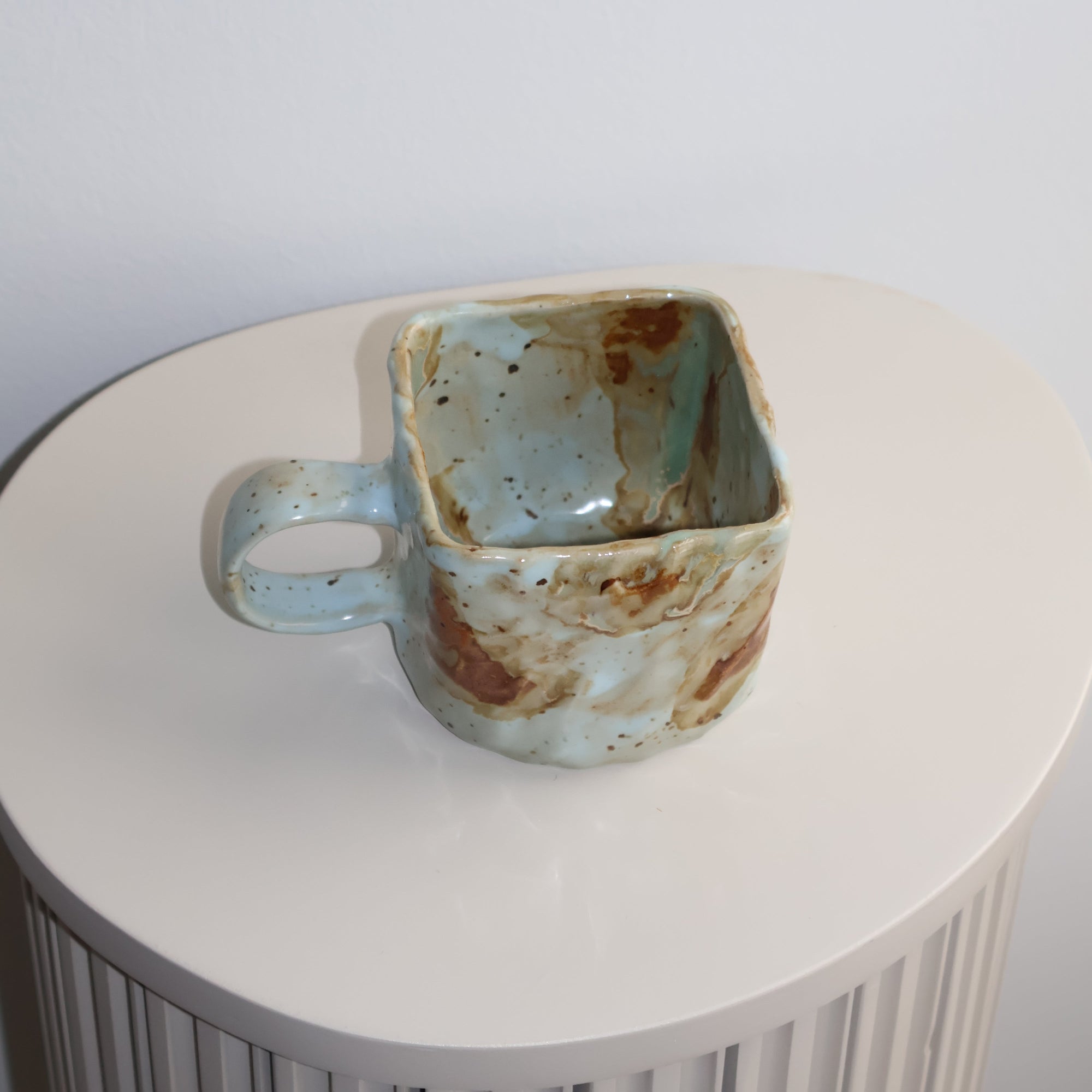 Ceramic cup with a textured surface on a white background