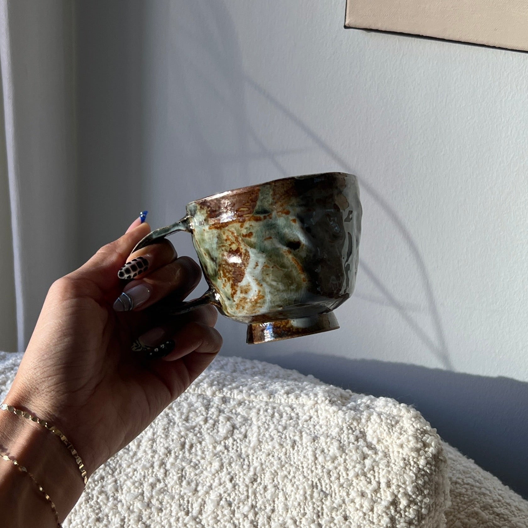 Person holding a cup with a blurred background