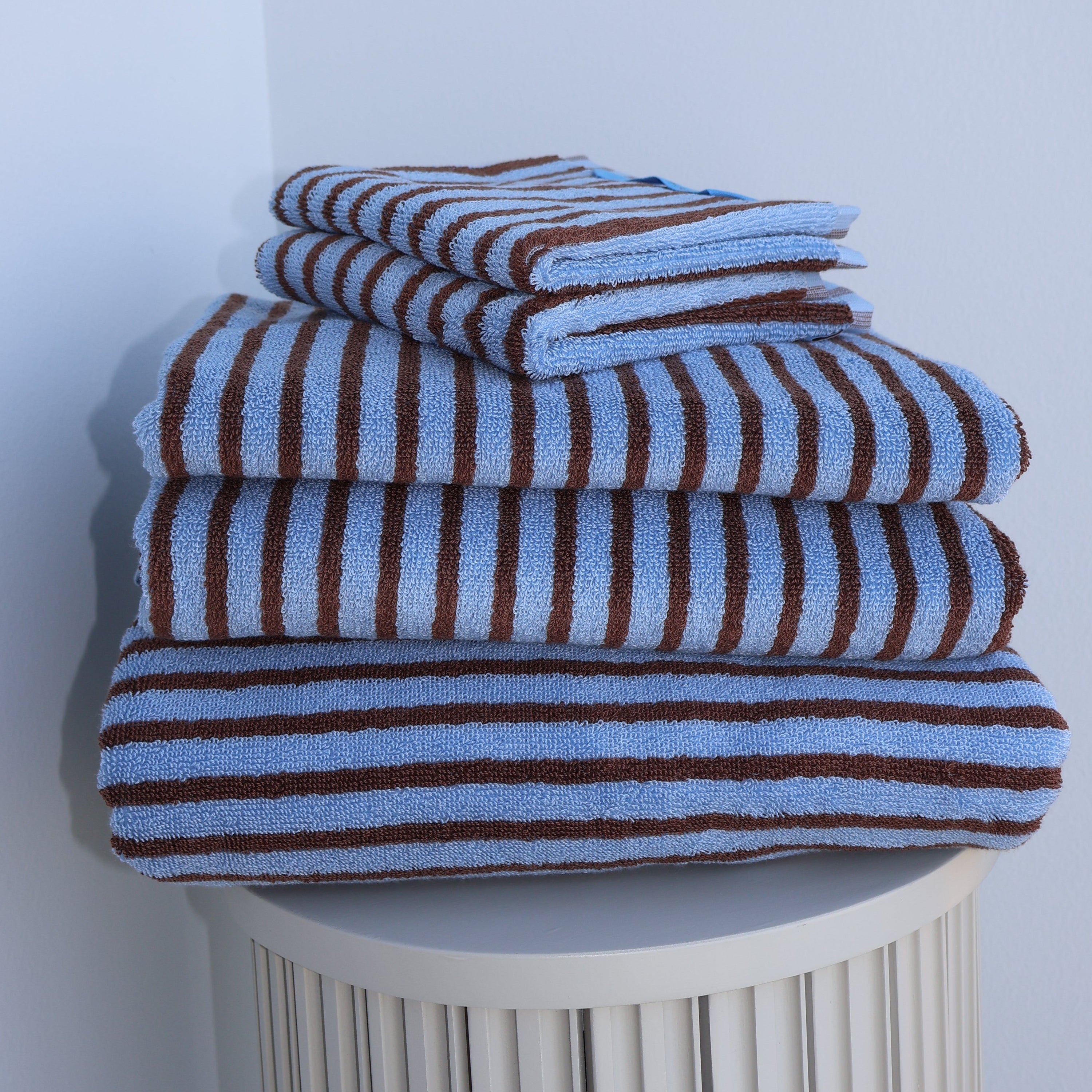 Striped blue and brown towel on a white background