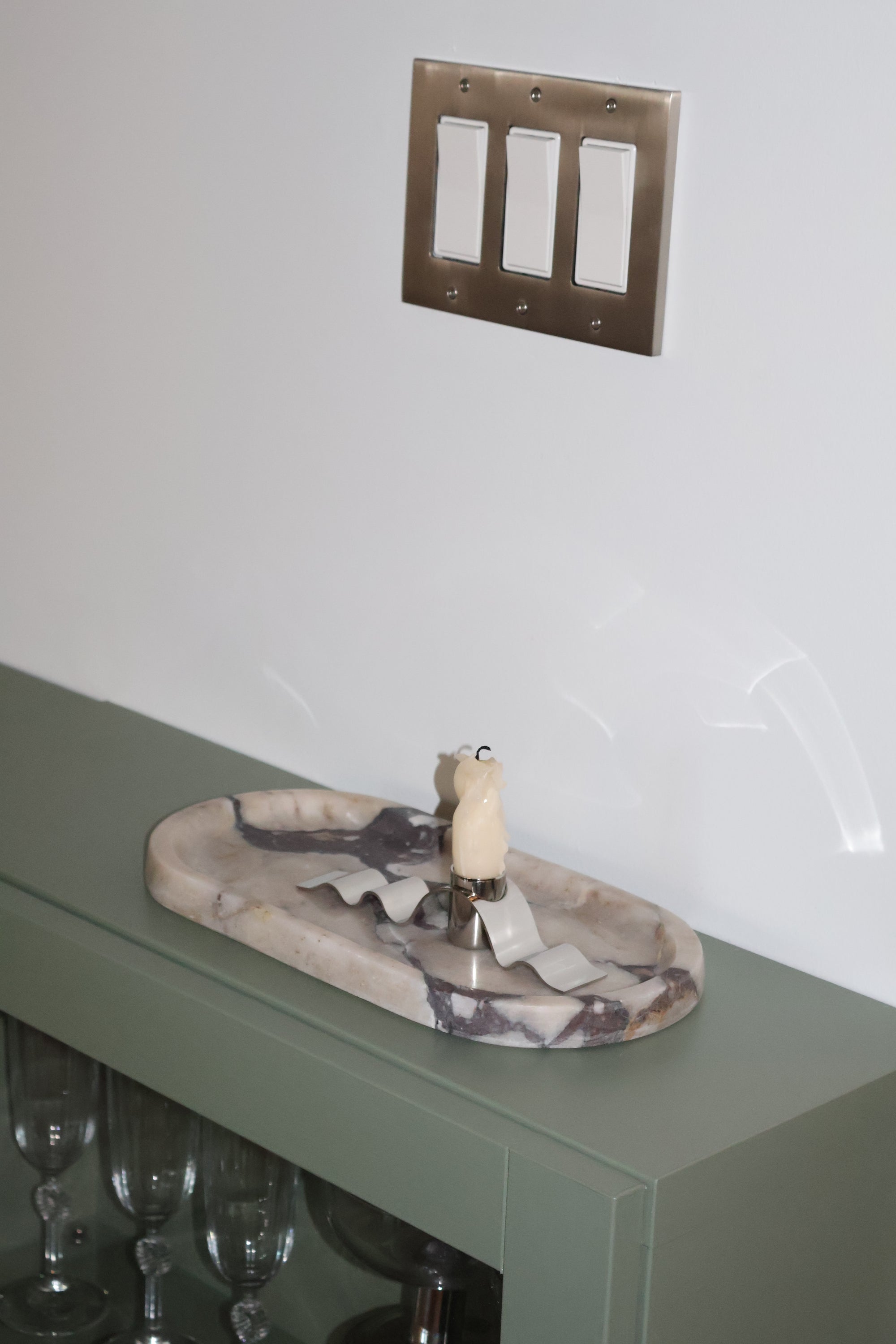 Camo-patterned door handle on a green door with a metallic lever