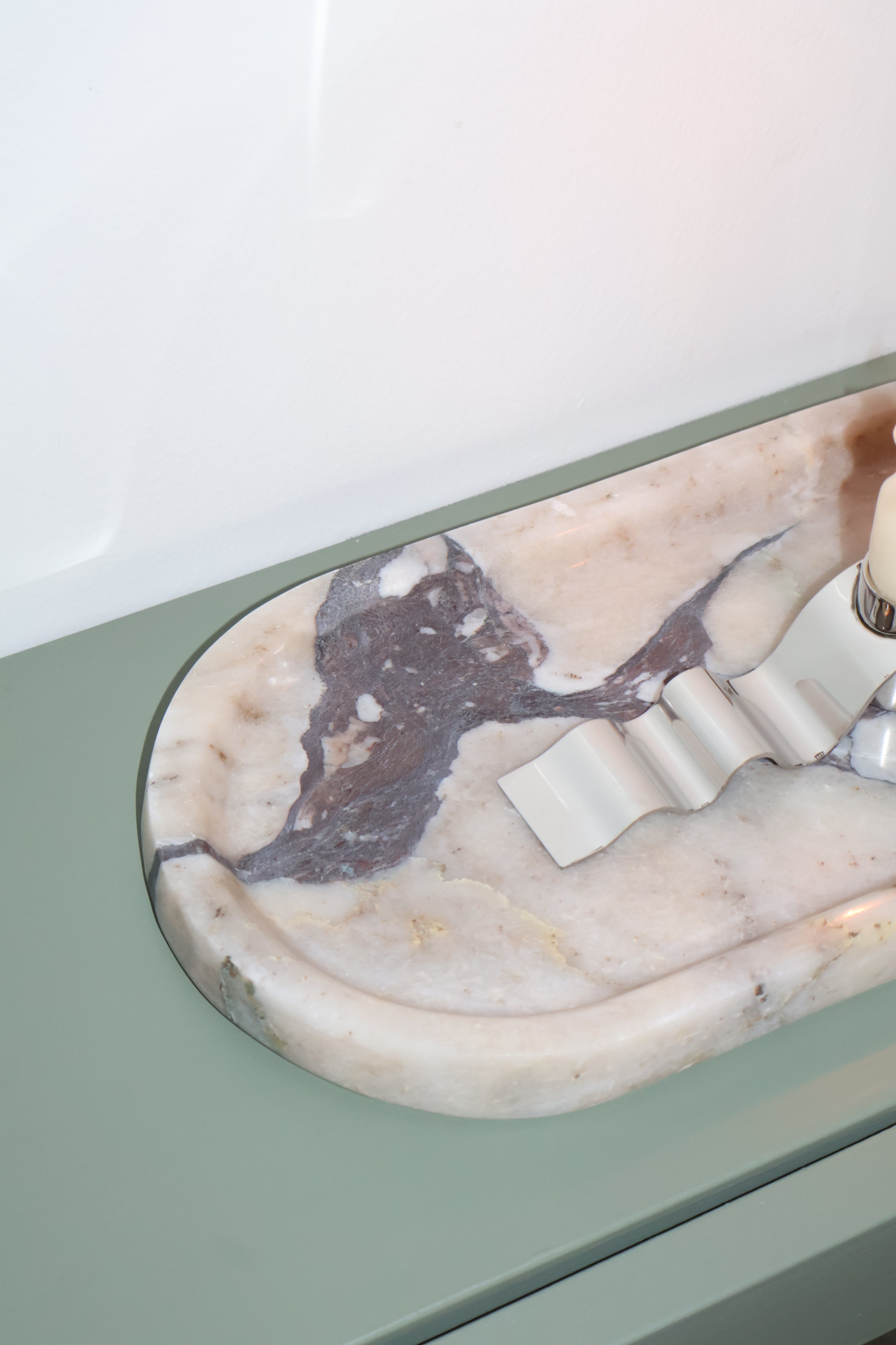 Marble-patterned object on a light green surface