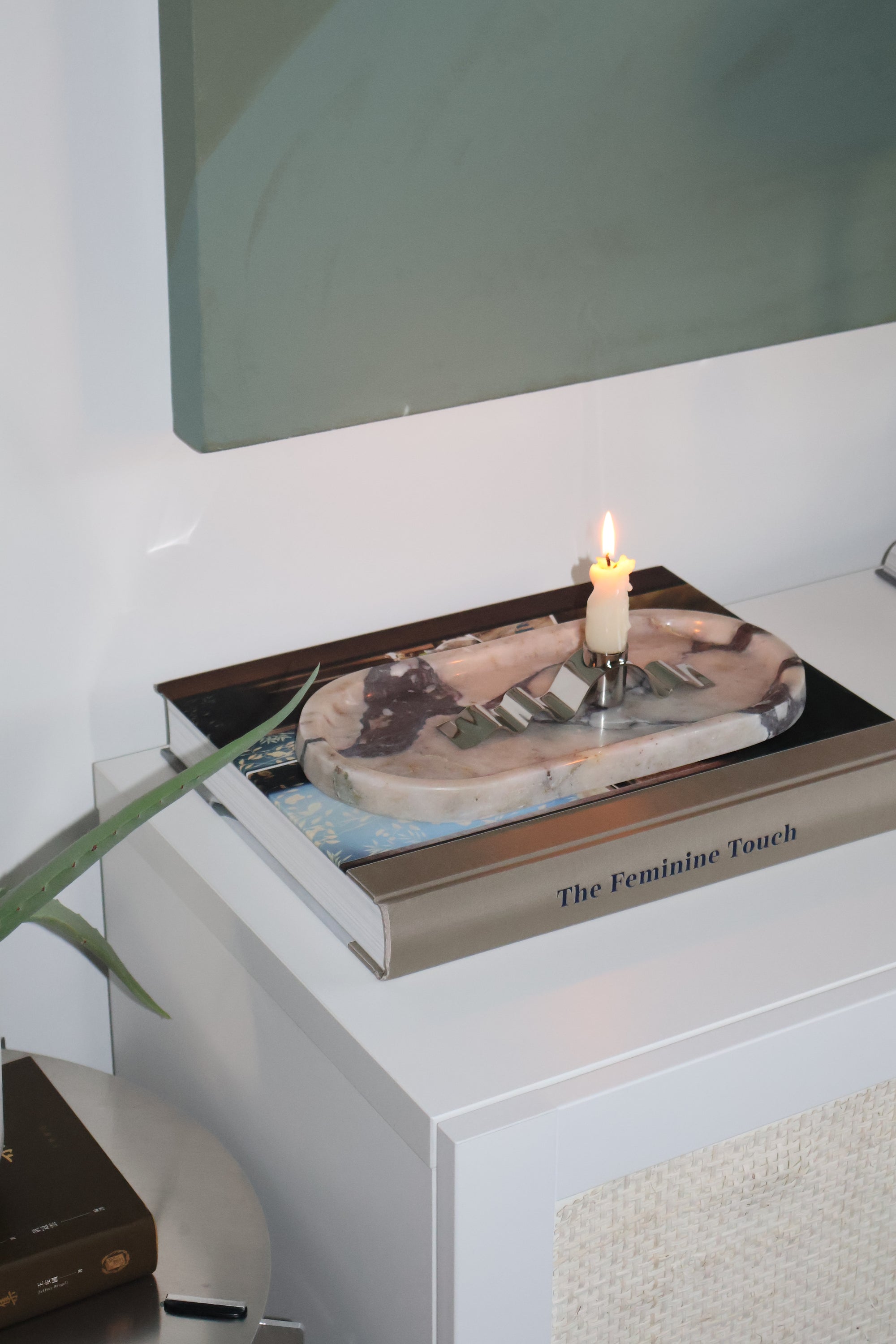 Product packaging with a candle on a white surface